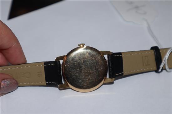 A gentlemans 14k Huguenin manual wind wrist watch, on associated leather strap.